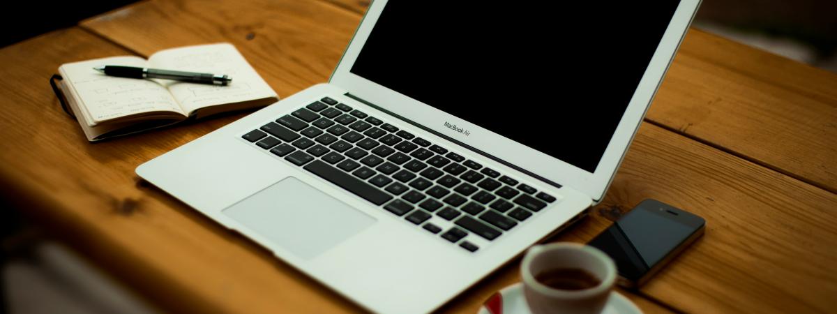 Laptop, coffee and notes ready to prepare a proposal