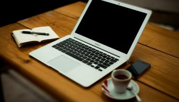 Laptop, coffee and notes ready to prepare a proposal